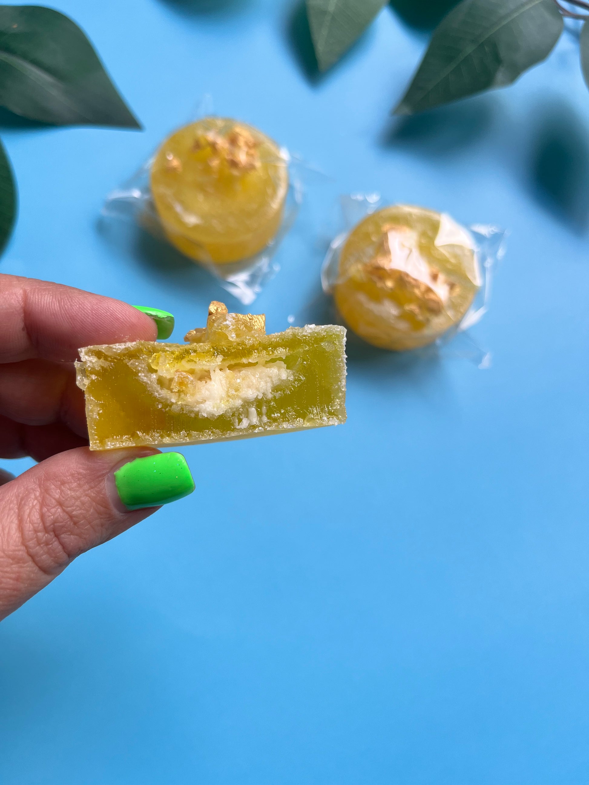 Cut-open candy showing creamy Raffaello-style filling with crispy texture