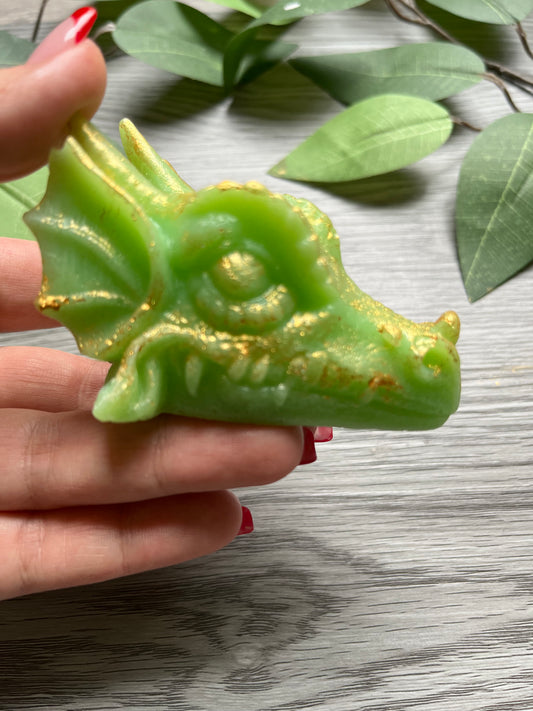 Green crystal candy dragon covered in edible gold, handmade with a crunchy sugar shell.