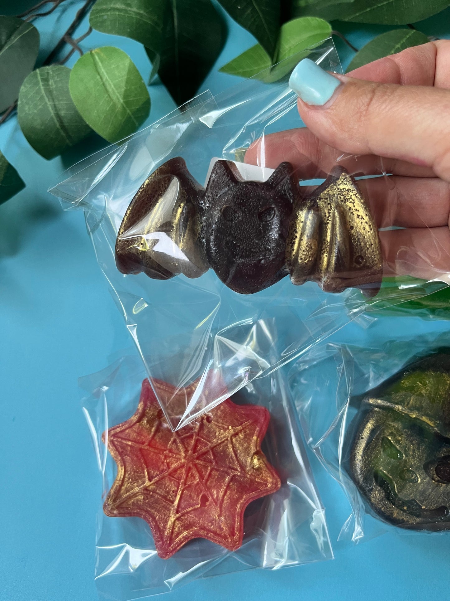 Black cherry crystal candy witch face with gold shimmer, stuffed with lemon raspberry skulls.