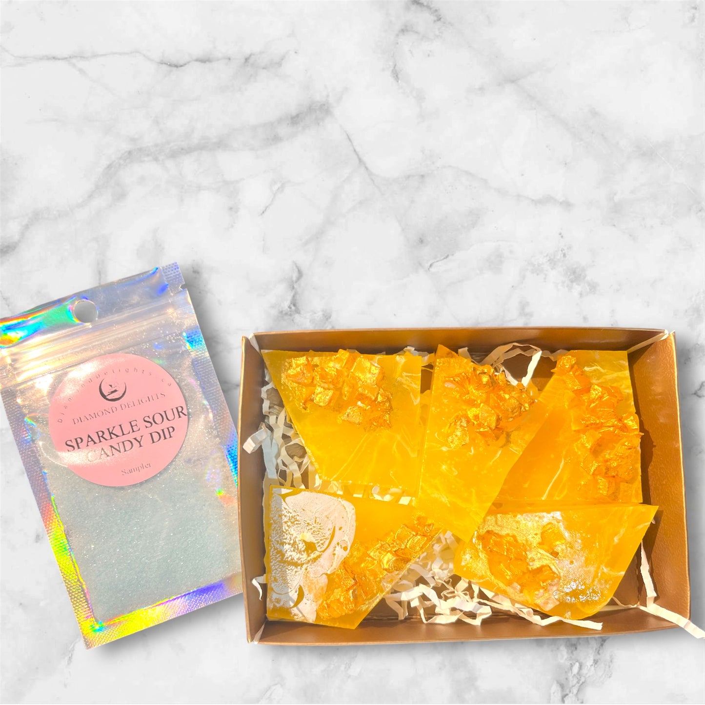 Yellow galaxy candy gem with metallic accents in gift packaging