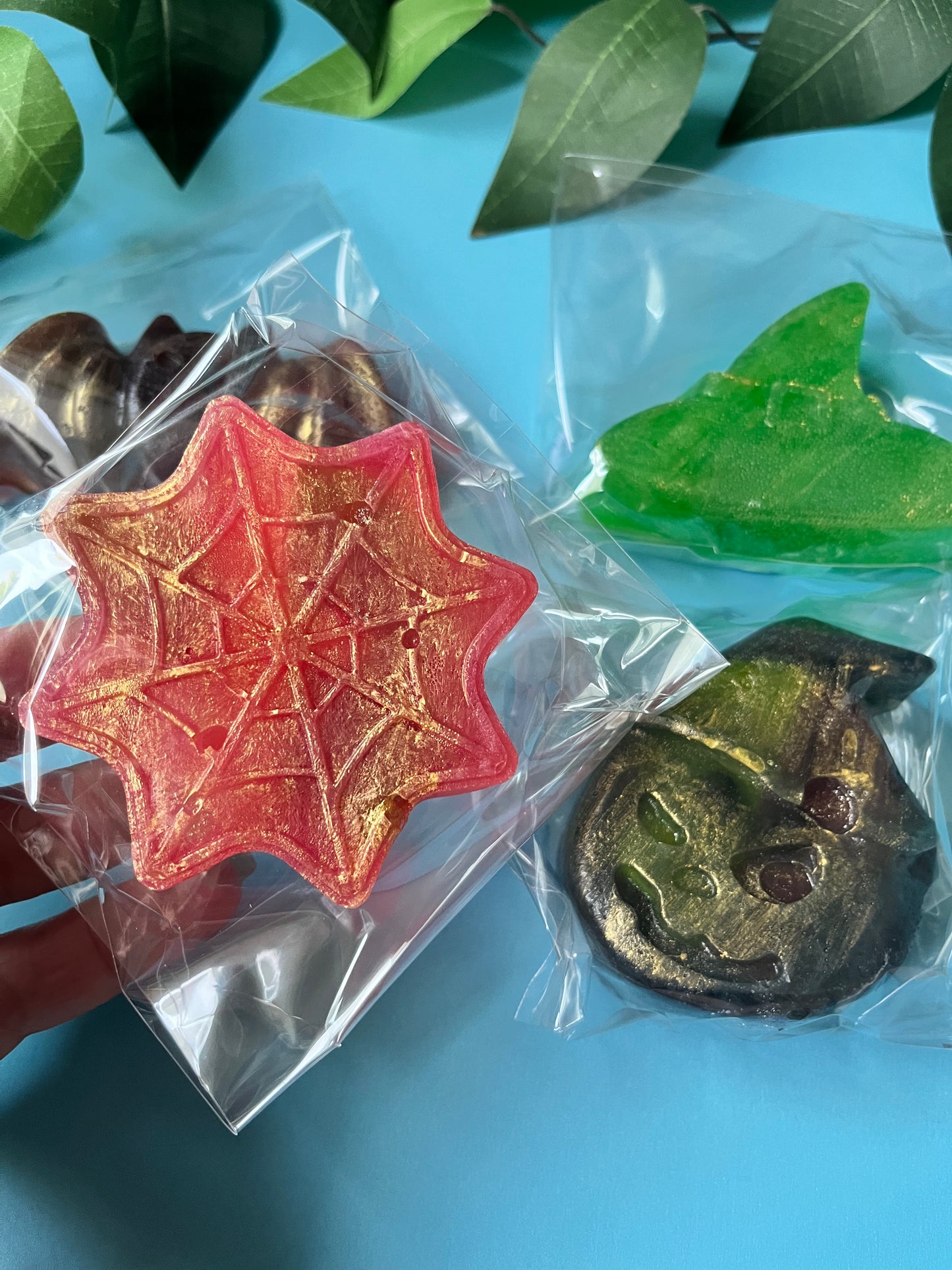 Red crystal candy spider web dusted with gold, stuffed with cola Swedish skulls.