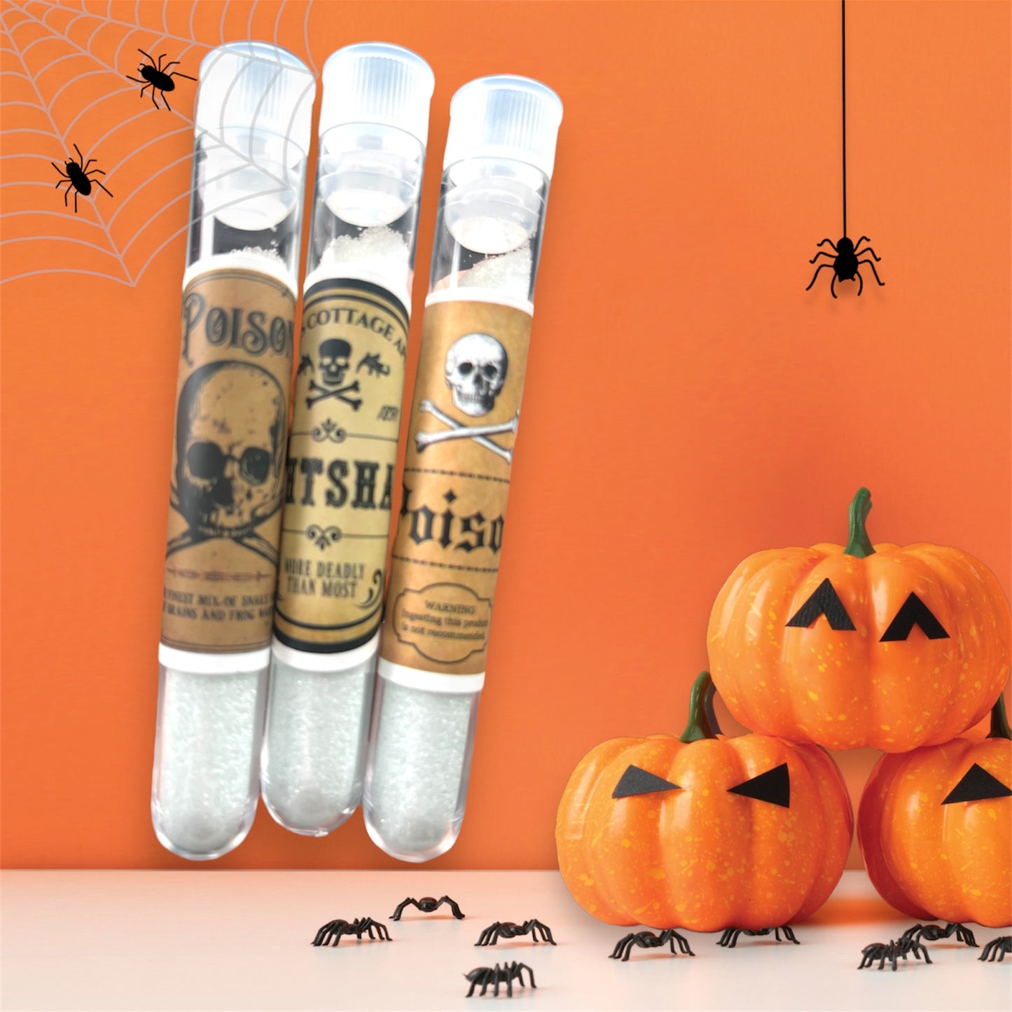 Halloween poison vial candy filled with sour sparkle dip powder, spooky skull and crossbones labels, apothecary style party favor.