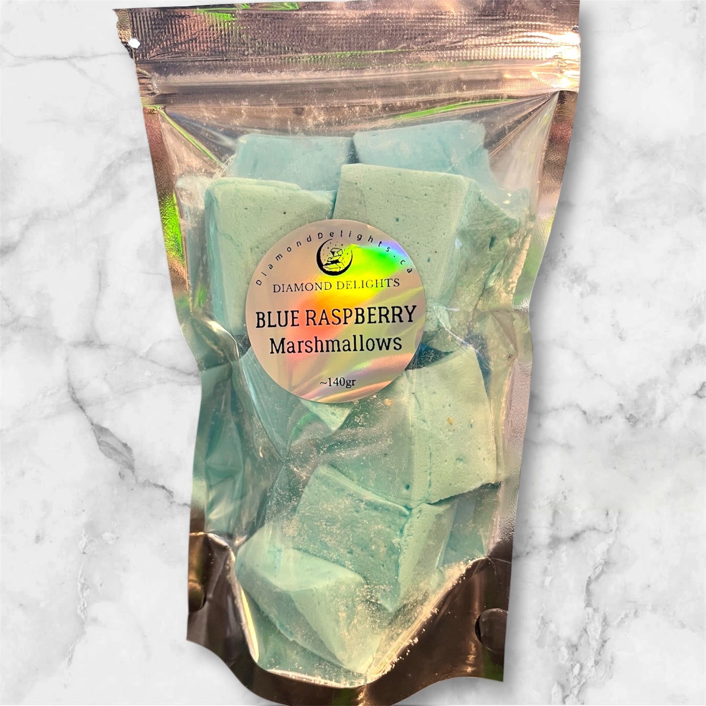 Bright blue fluffy marshmallows in a resealable bag, placed on a marble surface for contrast.