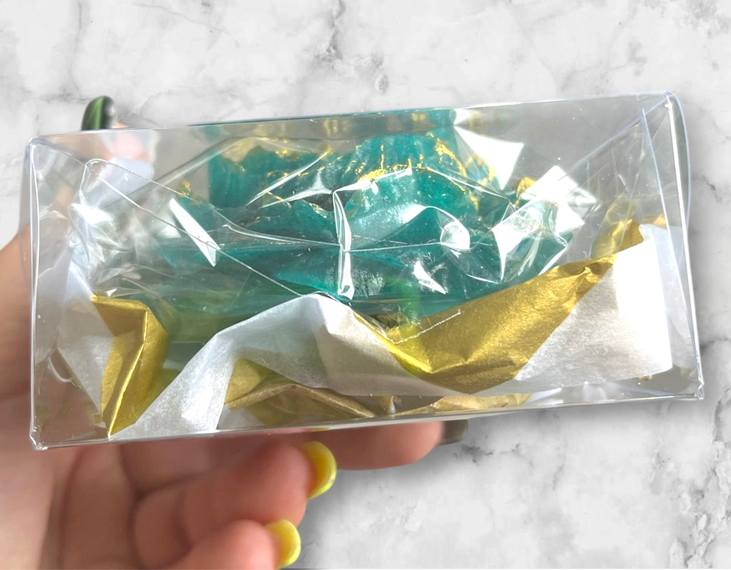 Side view of a crystal candy peony flower in a cute gift box