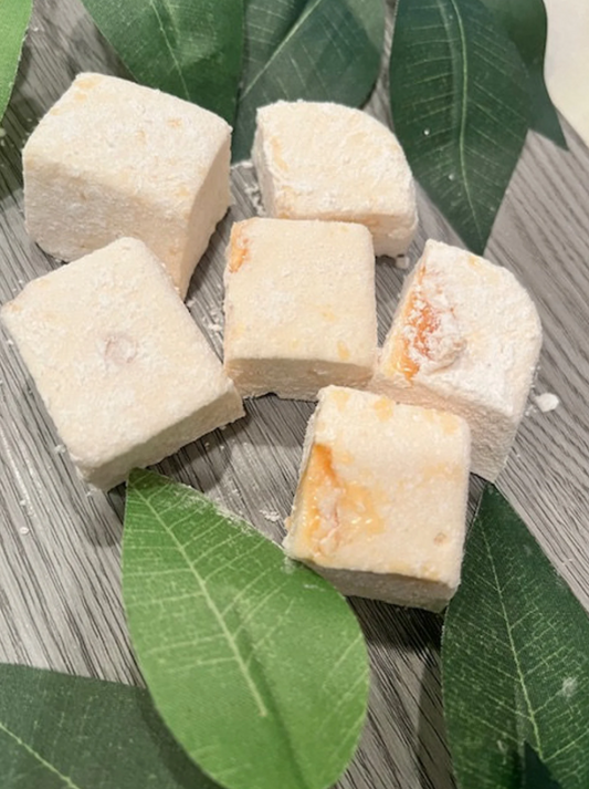 Salted caramel marshmallows on a grey background with visible caramel swirls.