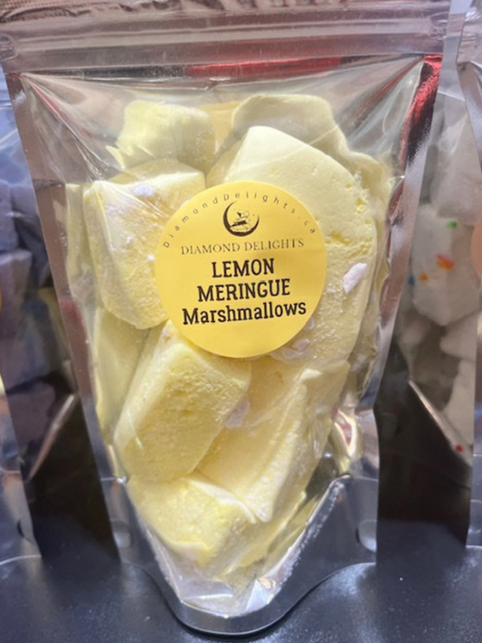 Bag of yellow lemon meringue marshmallows with crushed meringue and lemon drizzle, sealed in a clear holographic pouch.