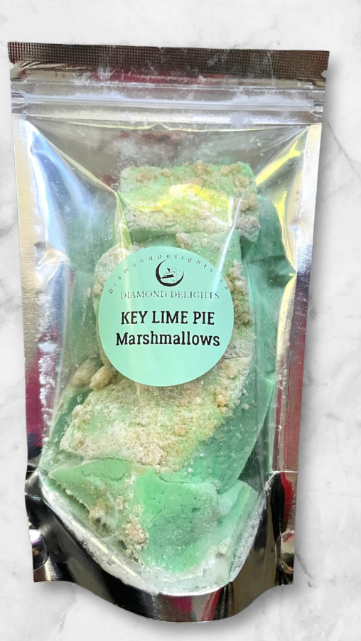Bag of bright green Key Lime Pie marshmallows with vanilla cracker topping in a resealable holographic pouch.