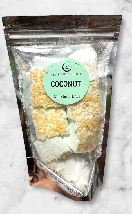Bag of coconut-flavored marshmallows with shredded coconut topping, sealed in a clear holographic pouch.
