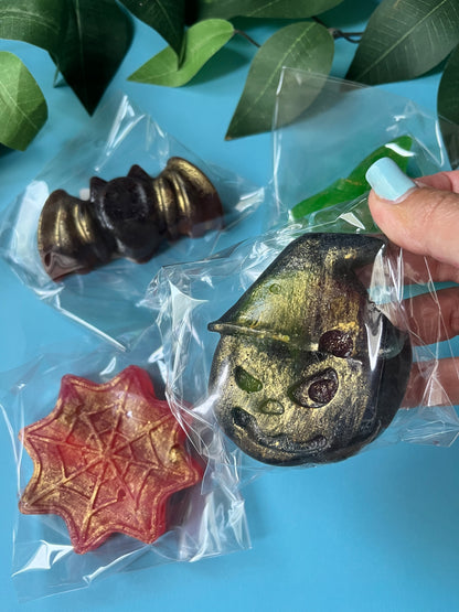Shimmering black crystal candy bat stuffed with caramel banana bubs, wrapped for Halloween.