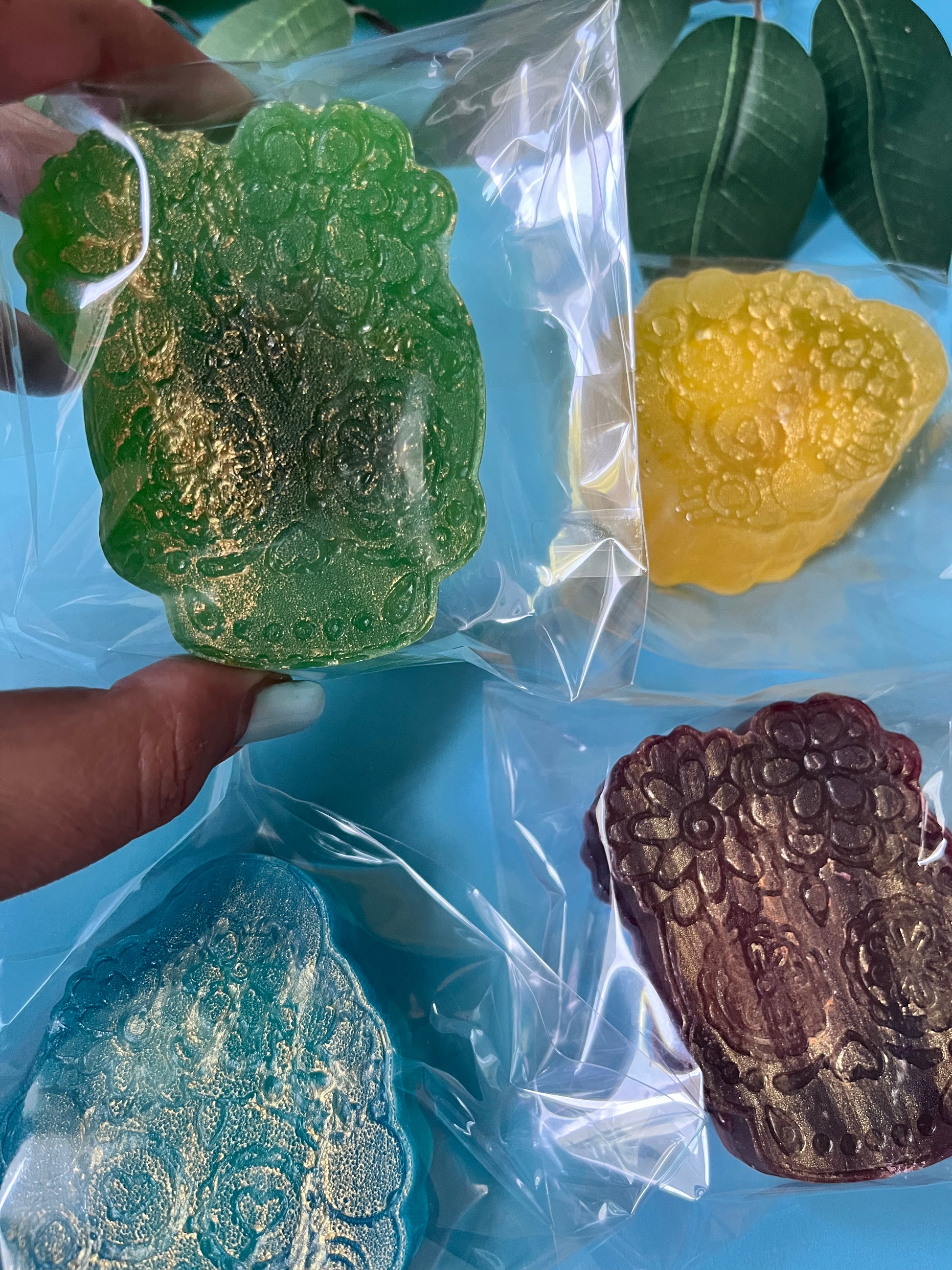 Delicious crystal candy in various colors on a blue surface.